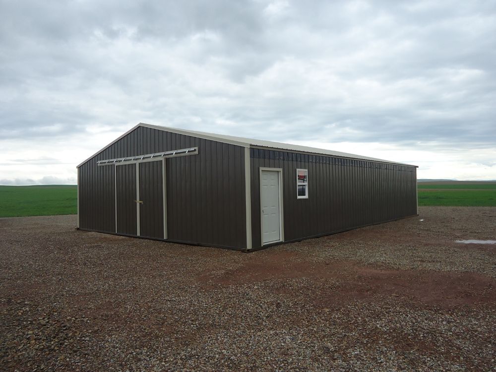 Three quarter exterior view of the 34 by 48 foot enclosed calving barn on a gravel pad