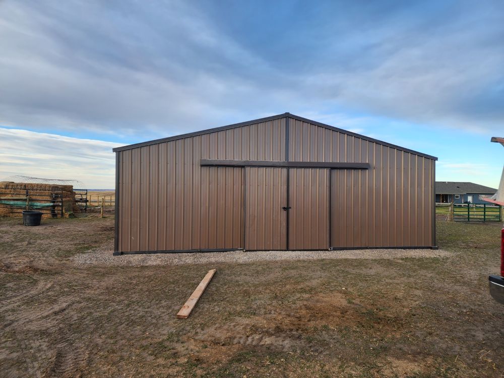 Front elevation of a 34-foot wide by 36-foot long metal horse barn with double sliding barn doors in burnished slate