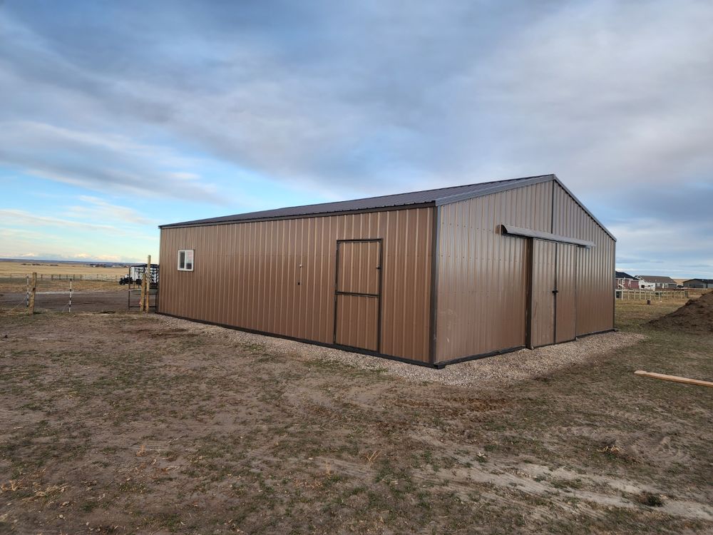 Exterior side of a metal horse barn showing the tack room man door and window